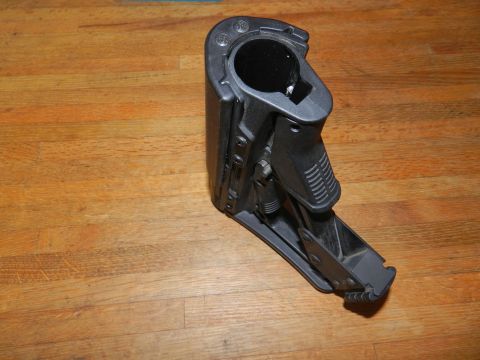 1996 Ford Bronco - Black adjustable firearm stock shown on a wooden surface.