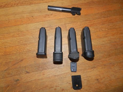 1996 Ford Bronco - Various gun parts, including a slide and magazines, are laid out on a wooden floor.