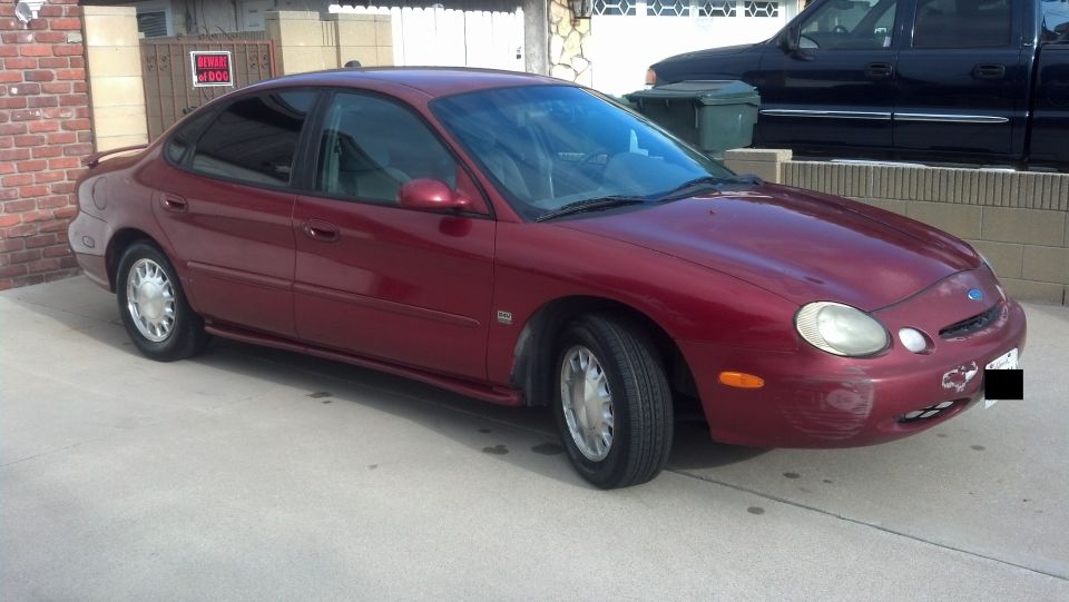 Red 1996 Ford Taurus sedan, 3q-front view