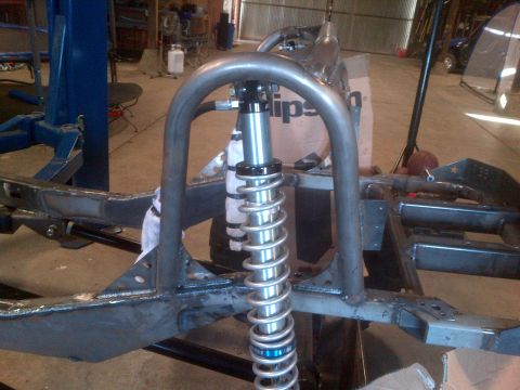 1985 Jeep CJ7 - Custom frame and suspension components are visible in this workshop setting.