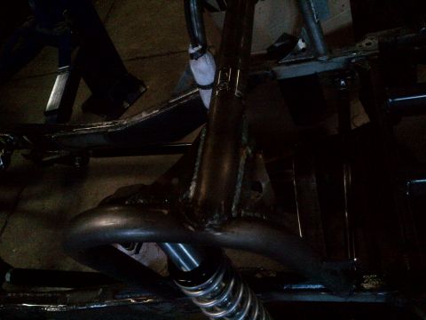 1985 Jeep CJ7 - Undercarriage view showing frame structure and a shock absorber.