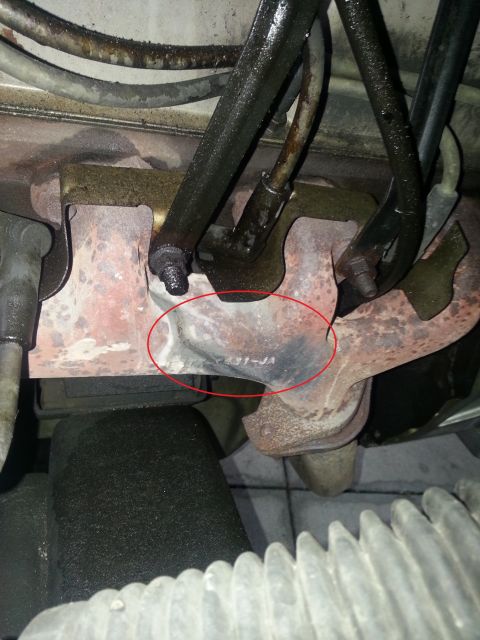 1994 Ford Bronco - A close-up view of a vehicle's exhaust manifold, showing a stamped part number.