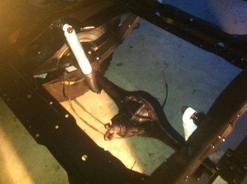 1979 Ford Bronco - Close-up view of a vehicle's rear axle and suspension system, likely during a restoration or repair.