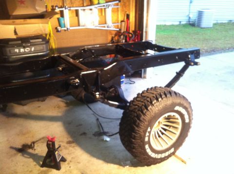 1979 Ford Bronco - The chassis and a wheel of a vehicle are visible, suggesting it is undergoing maintenance or restoration.