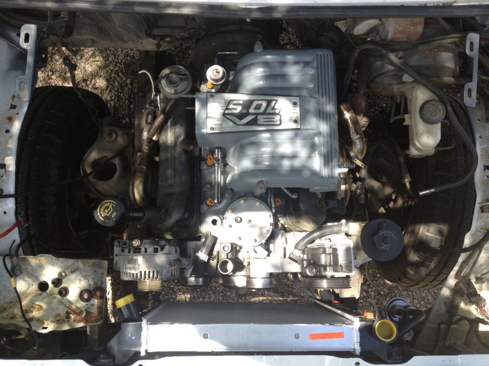Ford 5.0L V8 engine with intake manifold visible, showing "5.0L V8" badge