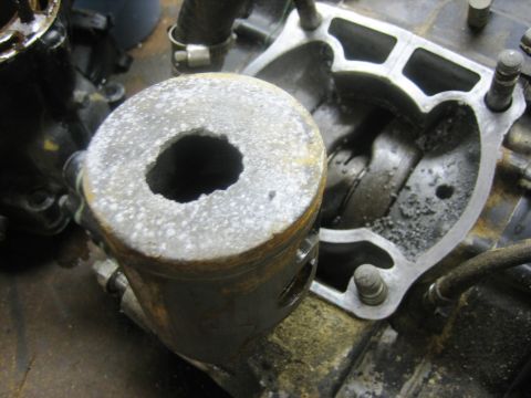 1900 Honda Big Red - Close-up of a disassembled engine cylinder and piston, showing internal components.