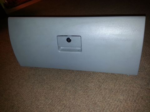 2002 Volkswagen Jetta - Glove box door from a vehicle, possibly for replacement or repair.