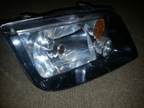 2002 Volkswagen Jetta - A single headlight assembly is shown against a textured background.