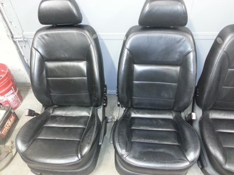 2002 Volkswagen Jetta - Black leather car seats are shown from the front, with a partial view of a third seat on the right.