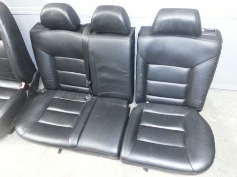 2002 Volkswagen Jetta - A set of black leather car seats, including rear bench and individual front seats, are displayed.