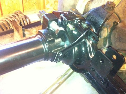 1979 Ford Bronco - Close-up view of a vehicle's front axle assembly, black painted metal parts and a visible watermark.
