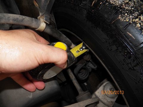 1998 Lincoln Mark VIII - A tape measure is used to check clearance near the tire, with a date stamp of 07/20/2013 visible.