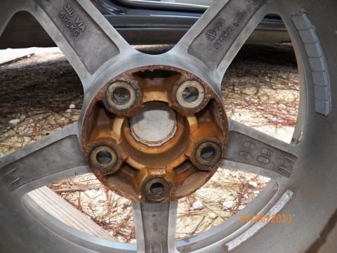1998 Lincoln Mark VIII - Close-up of a rusty car wheel hub showing its construction and markings.