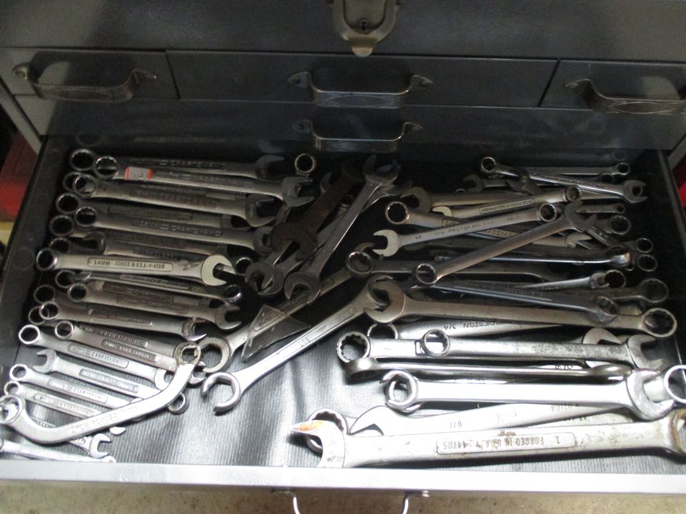 Toolbox drawer filled with various wrenches