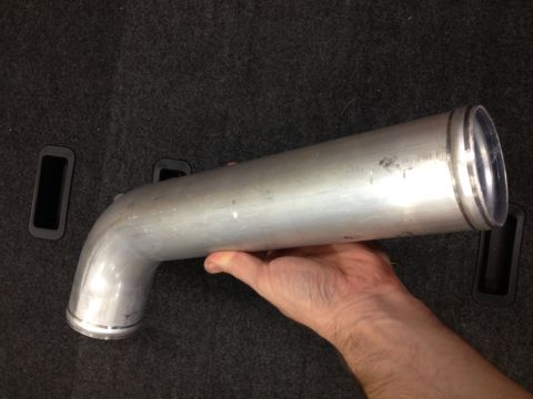 1998 Ford Crown Victoria - A person holds an aftermarket aluminum intake pipe, likely for a vehicle's engine.