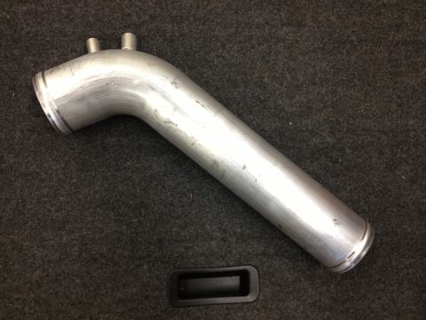 1998 Ford Crown Victoria - An aluminum intake pipe with two nipples is shown on a dark carpeted surface.