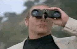 2000 Mercury Grand Marquis - Man with earrings and binoculars observes something in the distance.