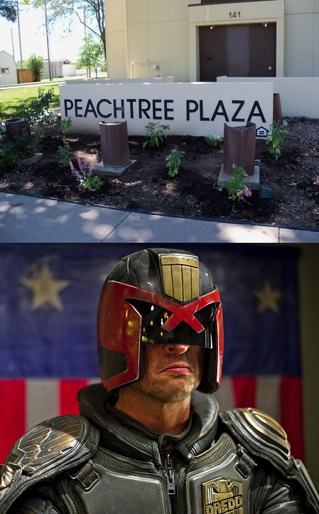 2000 Mercury Grand Marquis - A man dressed as Judge Dredd stands before a flag, with a "Peachtree Plaza" sign visible above.