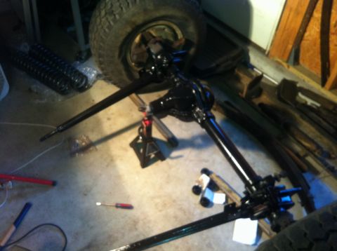 1979 Ford Bronco - A disassembled front axle assembly is shown in a garage setting.