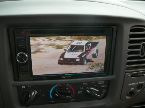 1988 Ford Bronco - A racing truck with TRD livery is displayed on the in-dash entertainment system.