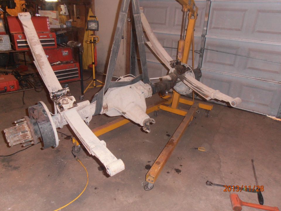 Front axle assembly with leaf springs suspended by an engine hoist