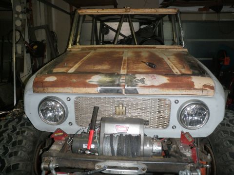 1961 International Scout 800 - Front view of a 1961 International Scout 800 undergoing restoration, a winch and roll cage.