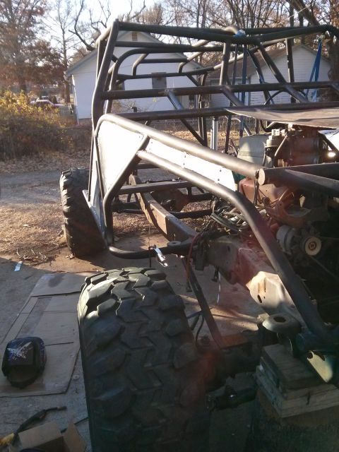 1986 Ford Bronco - Custom off-road buggy frame under construction, large tires and an exposed engine bay.