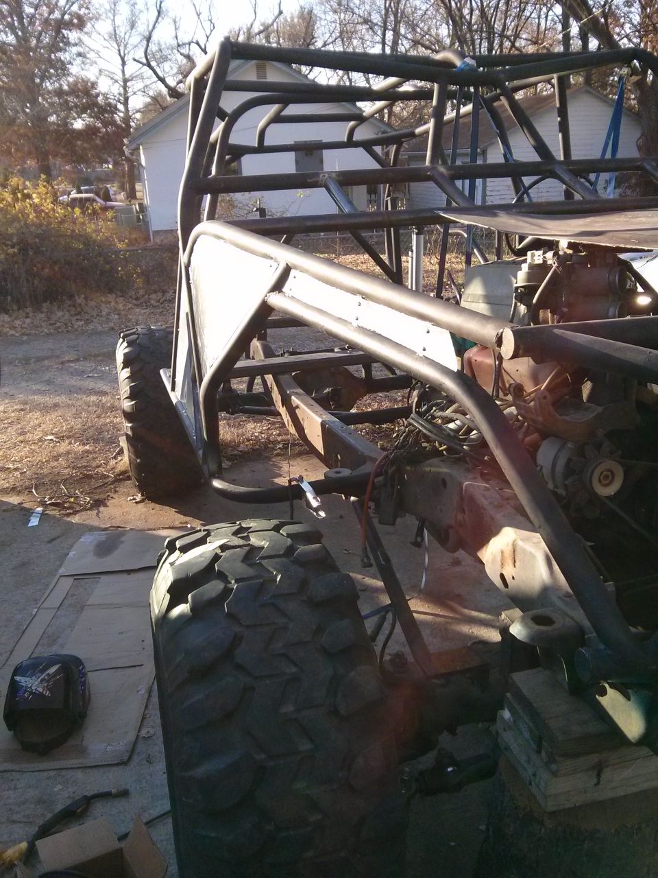 Off-road buggy frame with large tires and exposed engine