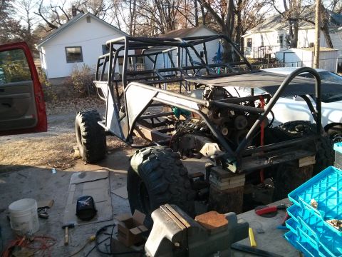 1986 Ford Bronco - Custom off-road buggy frame and engine assembly in progress outdoors.