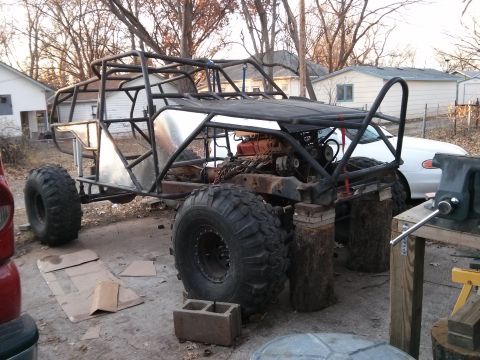 1986 Ford Bronco - This custom-built buggy, likely a project in progress, features a robust roll cage and oversized tires, with its engine and chassis compone…