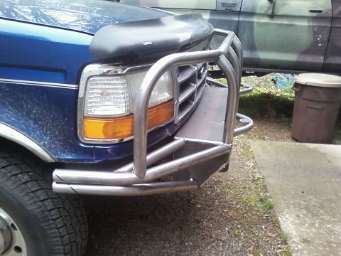 1989 Ford Bronco - Front view of a blue truck from the early 1990s, equipped with a heavy-duty brush guard.