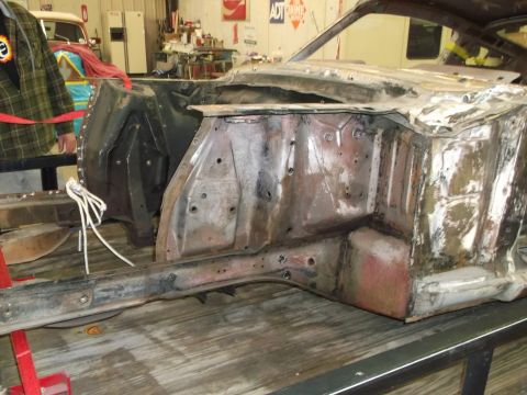 1967 Ford Mustang - Front section of a 1967 Ford Mustang undergoing restoration, showing the engine bay and frame.