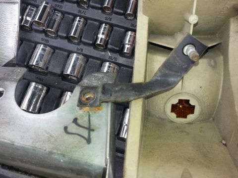 1994 Ford Bronco - Close-up of a socket set and a vehicle part, possibly for headlight assembly.