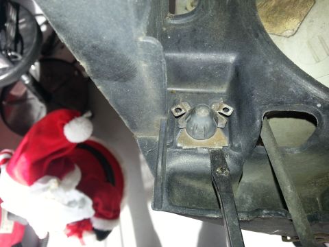 1994 Ford Bronco - This photo shows a close-up of a vehicle's headlight mounting bracket, not the entire vehicle.