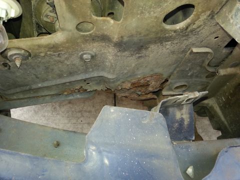 1994 Ford Bronco - Severe rust damage is visible on the undercarriage of this vehicle.