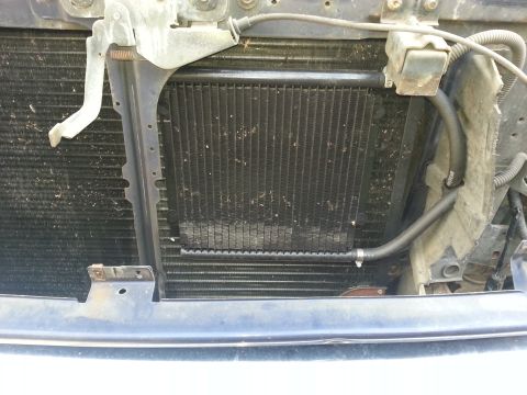 1994 Ford Bronco - Close-up view of the vehicle's radiator and transmission cooler assembly.