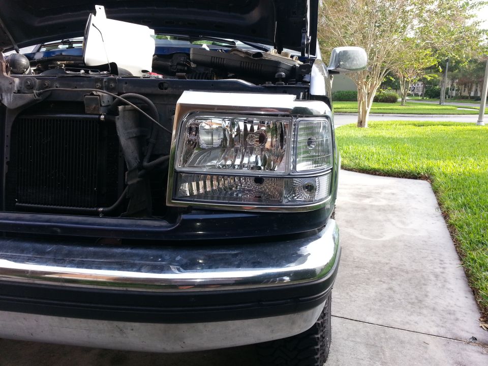 Black Ford F-Series truck headlight assembly with chrome trim, viewed from the front