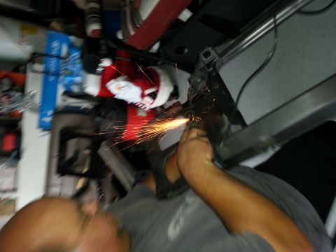 1994 Ford Bronco - A person is shown working on the headlight assembly of a vehicle, with tools and parts visible.