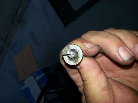 1994 Ford Bronco - A person holds a small metal component, possibly a fastener or valve, in their hand.