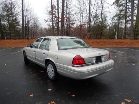 2001 Ford Crown Victoria - This silver 2001 Ford Crown Victoria is shown from the rear three-quarter angle in a parking lot.