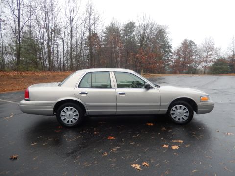 2001 Ford Crown Victoria - This silver 2001 Ford Crown Victoria is seen from the side on a wet, overcast day.