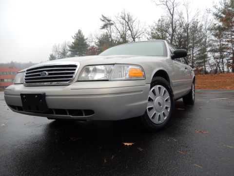2001 Ford Crown Victoria - This 2001 Ford Crown Victoria is captured from a low angle, highlighting its front grille and side profile.
