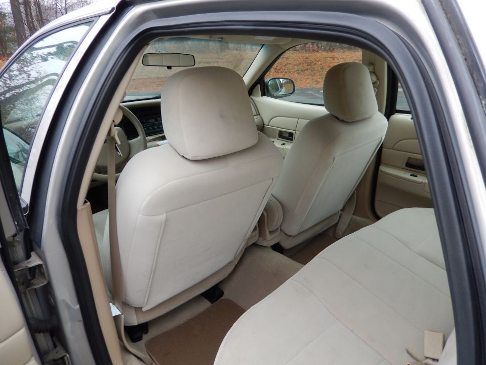 Interior view of a 2001 Ford Crown Victoria showing beige seats and dashboard