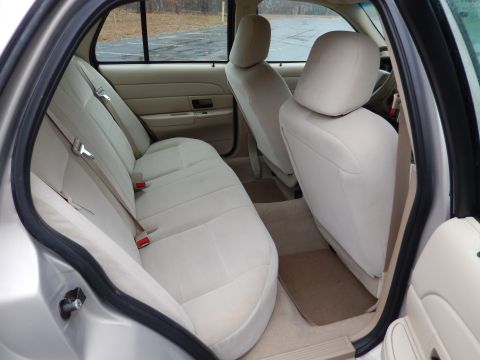2001 Ford Crown Victoria - Interior view of a 2001 Ford Crown Victoria, highlighting the spacious seating and neutral color scheme.