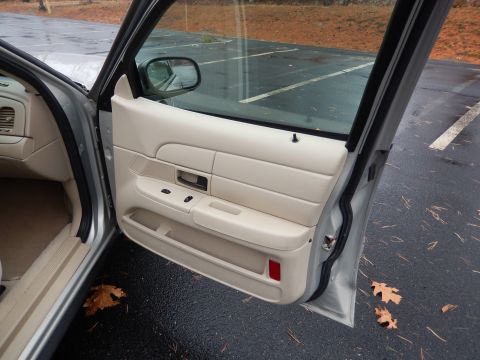 2001 Ford Crown Victoria - Interior view of a 2001 Ford Crown Victoria, showing the driver's side door panel and dashboard.