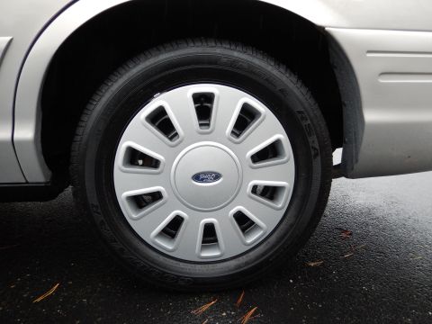 2001 Ford Crown Victoria - The silver hubcap on the 2001 Ford Crown Victoria features the Ford logo and a multi-spoke design.