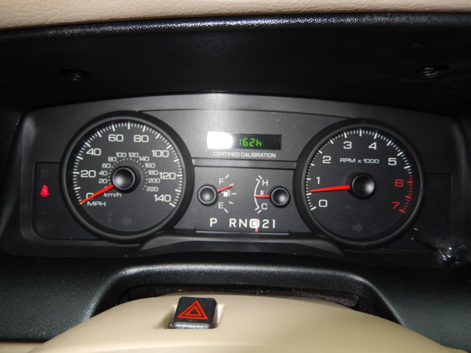 Dashboard gauges with speedometer, tachometer, fuel gauge, and gear selector