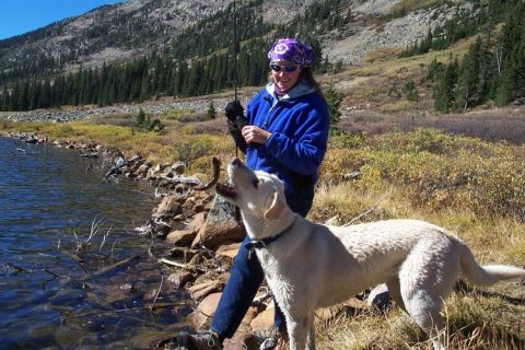 1990 Ford Bronco - A woman and her dog enjoy a day of fishing by a mountain lake.