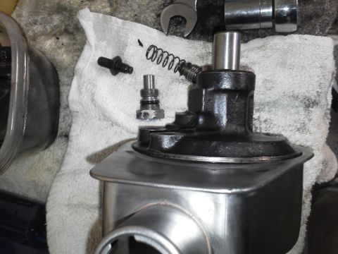 1993 Ford Bronco - Disassembled power steering pump components are laid out on a towel for service.