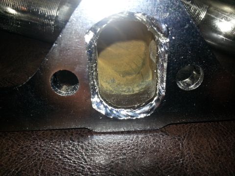 1994 Ford Bronco - Close-up view of an exhaust manifold flange, showing the connection point for exhaust pipes and mounting hardware.